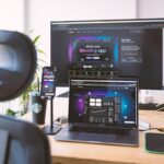 a desk with a laptop and a monitor on it