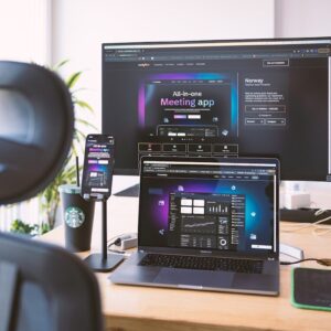 a desk with a laptop and a monitor on it